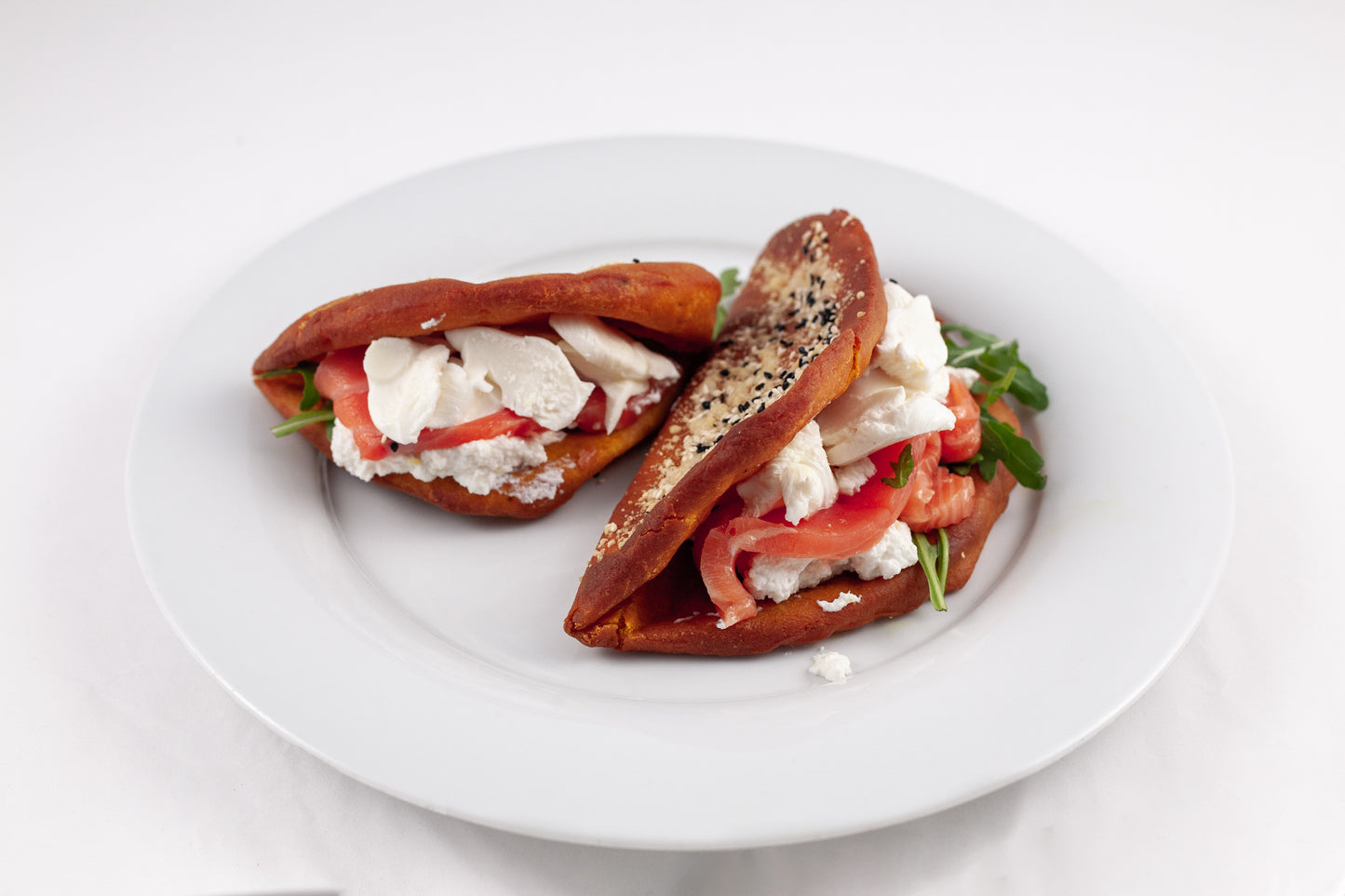 Open panzerotto with beetroot dough, marinated salmon and lime ricotta